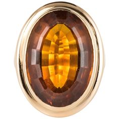 Ring in 18 karat yellow gold. Retro ring, it is closed-set in the center of an oval citrine. The basket is perforated to let in the light under the gem. Total weight of citrin: 11.50 carats approximately. Height: 2.3 cm, width: 1.7 cm, thickness: 9.4 mm, width of the ring at the base: 3.3 mm. Total weight of the jewel: 11.7 g approximately. US Size : 5,75 ; Free resize, please contact us. Retro ring - Work of 1960s. Our opinion: A voluminous citrine ring, totally retro. Specialized in antique an Gold Vintage Ring, Yellow Gold Cocktail Ring, Retro Ring, Gold Cocktail Ring, Gold Cocktail, Colombian Emeralds, Citrine Ring, Vintage Ring, Magazine Design