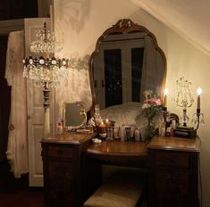 a vanity with a mirror and candles on it