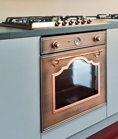 a stove top oven sitting inside of a kitchen