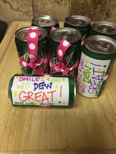 six cans of soda with pink polka dots on them and the words smile you will dew great