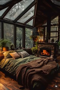 a bed sitting inside of a bedroom next to a window filled with lots of plants