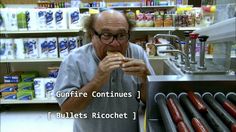 an older man eating a hot dog in front of a display of condiments