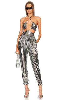 Find L'ACADEMIE Blair Jumpsuit In Metallic Silver on Editorialist. L'Academie Blair Jumpsuit in Metallic Silver. - size L (also in M, XL) L'Academie Blair Jumpsuit in Metallic Silver. - size L (also in M, XL) 94% polyester 6% elastane. Made in China. Hand wash. Pull-on styling Halterneck and back S-hook closure. Side slant pockets. Drawstring tie closure at leg opening. Pleated metallic fabric. LCDE-WC65. LAJS59 H22. L'Academie has mastered the art of elegant, sophisticated dressing with chic an Metallic Jumpsuits And Rompers For Night Out, Elegant Metallic Fitted Jumpsuits And Rompers, Elegant Fitted Metallic Jumpsuits And Rompers, Elegant Fitted Metallic Jumpsuit, Missy Elliott, Wardrobe Makeover, Elegant Sophisticated, Song Of Style, Classic Heels