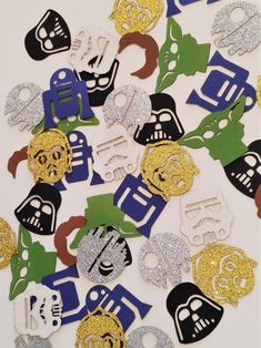 a pile of assorted cut outs with masks and numbers on them, all in different colors