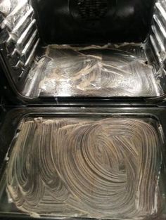 the inside of an oven that is covered in tin foil and has been smothered with icing