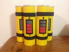 three yellow batteries are sitting on a table