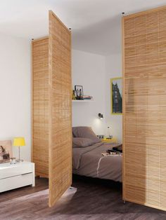 a bedroom with wooden slats on the walls