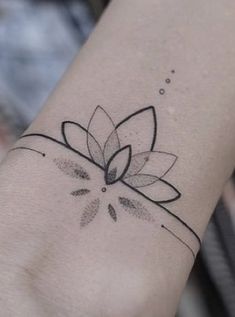 a black and white photo of a flower on the wrist