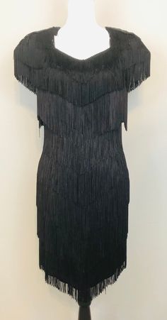 "Vintage Petite Black Fringe Cocktail Dress with Sequin and Beaded Epaulets and Keyhole Back / Gatsby Fringe Dress Measurements:    Bust: 36/38\" Waist: 30/32\" Hips: 36/38\" Length: 34\" (at the shortest point) Tag Size: 12 Petite Material: Polyester  Dress is in very good condition." Night Out Beaded Fringe Flapper Dress, Black Gatsby Style Formal Dress, Evening Dresses With Beaded Fringe, Fitted Flapper Dress With Rhinestone Fringe For Cocktail, Elegant Fitted Flapper Dress With Rhinestone Fringe, Evening Fitted Flapper Dress With Rhinestone Fringe, Fitted Cocktail Dress With Beaded Fringe, Evening Flapper Dress With Rhinestone Fringe, Elegant Fitted Flapper Dress For Night Out