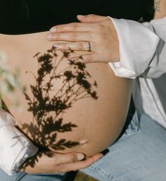 a pregnant woman's shadow on her belly