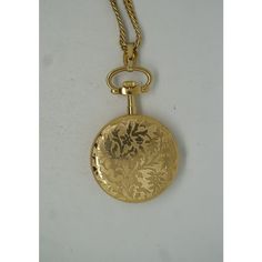 Vintage University of Dayton (UD) Accutron Bolova floral etched pocket watch and chain / fob.  Circa 1970s.   DIMENSIONS  1.25" x 0.25" x 2"  (Width x Depth x Height) / Chain Length - 24" / 35.1 g Vintage Hallmarked Round Pocket Watch, Antique Gold Pocket Watch With Locket For Formal Occasions, Formal Antique Gold Pocket Watch With Locket, Engraved Antique Gold Pocket Watch For Formal Occasions, Antique Gold Locket Pocket Watch For Formal Occasions, Vintage Hallmarked Yellow Gold Pocket Watch, Vintage Hallmarked Pocket Watch For Formal Occasions, Vintage Engraved Round Jewelry And Watches, Vintage Yellow Gold Pocket Watch With Polished Finish