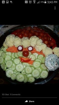 a plate full of vegetables with a face made out of them