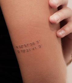 a woman's arm with the word tattoo on it