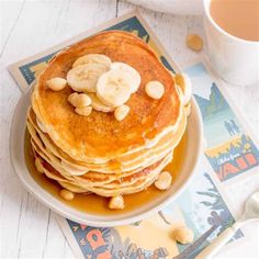 a stack of pancakes topped with bananas and peanut butter