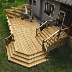 a large wooden deck with steps and railings