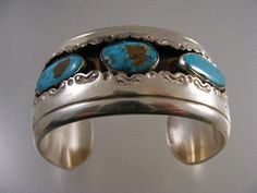 "Lovely vintage Signed Native American Turquoise Shadowbox Cuff Bracelet in Sterling Silver. Bracelet 1.29\" (32.9mm) wide. Turquoise stones measure 10x19mm, 12x16mm, and 9.5x20mm. Interior of bracelet measures 5 1/8\", with an additional 1 1/8\" opening gap, for a total of 6 1/4\". This cuff is not sizable. Bracelet has a nice weight of 67.5 grams. Signed GD as can be seen in photo #5. Tests positive for sterling. In very good pre-owned condition." Turquoise Bangle Cuff Bracelet For Formal Occasions, Vintage Turquoise Stamped Bracelets, Vintage Turquoise Bangle Cuff Bracelet, Vintage Turquoise Stamped Cuff Bracelet, Antique Turquoise Bangle, Antique Turquoise Bangle Cuff Bracelet, Vintage Turquoise Bracelets As Gift, Vintage Turquoise Bangle As A Gift, Turquoise Stamped Cuff Bracelet Collectible