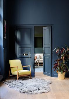 a living room with blue walls and wooden floors