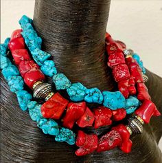 This triple strand necklace features rustic red branch corals, turquoise blue magnesites and accents of silver tone stamped tribal bi-cone beads flanked by rhinestone rondelles. This is a bold, chunky and moderately heavy piece where you can twist the strands to your preferred satisfaction and make this a choker style if needed. Adjusts from 18-21" with silver tone hardware, a lobster claw clasp and a 3" extender chain. From the Atelier of Kat Kouture. Red Bohemian Beaded Necklaces With Stones, Bohemian Red Beaded Necklaces With Stones, Bohemian Red Coral And Turquoise Jewelry, Bohemian Turquoise And Red Coral Necklace, Bohemian Turquoise Beaded Necklaces In Red Coral, Bohemian Red Coral Beaded Necklace In Turquoise, Bohemian Turquoise Beaded Necklace With Red Coral, Bohemian Turquoise And Red Coral Beaded Necklaces, Bohemian Turquoise And Red Coral Beaded Necklace