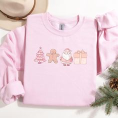 Stay cozy and festive with our Pink Christmas Tree Sweatshirt, the perfect blend of style and holiday cheer! Whether you're snuggling up by the fire or heading out for winter fun, this cute holiday crewneck adds a pop of color to your seasonal wardrobe. Available for women, kids, toddlers, and babies, it's a heartwarming gift that brings families together during the most magical time of the year. Spread the joy and make unforgettable memories this holiday season with this comfy, stylish winter p Pink Christmas Sweater, Doodles Christmas, Holiday Crewneck, Seasonal Wardrobe, Winter Pullover, Pink Christmas Tree, Holiday Sweatshirt, Unforgettable Memories, Winter Fun