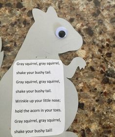 a piece of paper with a squirrel on it's side and a poem written in the middle