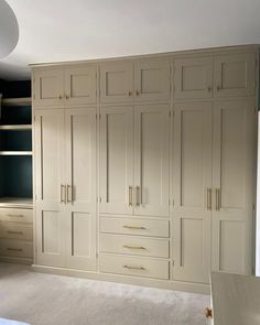 an empty bedroom with built in closets and carpeted flooring on the ground