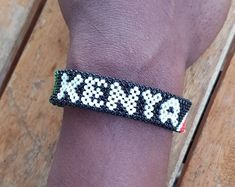 Kenyan flag bracelet which is 100% handmade using original beads. We customize the bracelet with the name of your choice. Makes a great gift. Thread used is water resistant. Note; you can request any country flag. Measure your wrist size accordingly. ALL items are shipped through DHL express. Jamaican Bracelets Beads, Ghana Bracelet, East African Bracelets, Maasai Bracelet Kenya, Beaded Bracelet Angolan Flag, Kenyan Flag, Bracelets Name, African Beaded Bracelets, Flag Bracelet