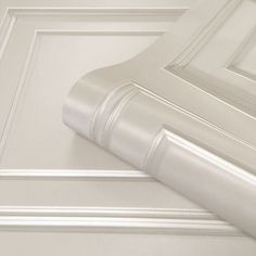 the corner of a wall with white trim