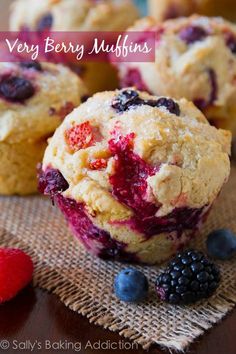 berry muffins on a table with berries and raspberries