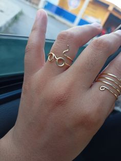 a woman's hand with rings on her fingers