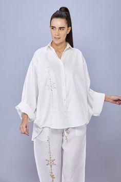 White shirt featuring pearl and diamond snowflake embroidery in the front with batwing sleeves. - Aza Fashions Elegant Embroidered Tops With Relaxed Fit, Elegant Cotton Tops With Embroidered Cuffs, Elegant Embroidered Relaxed Fit Blouse, Long Sleeve Blouse With Pearl Embroidery, White Resham Embroidered Kaftan For Festivals, White Embellished Long Sleeve Shirt, White Long Sleeve Embellished Shirt, White Resham Embroidery Kaftan Tunic, White Embroidered Mulmul Sets