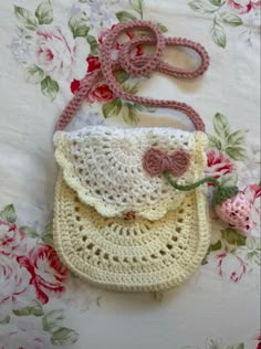 a crocheted purse sitting on top of a bed