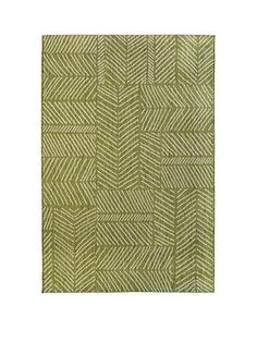 a green rug with white lines on it