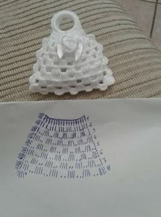 a crochet bag sitting on top of a bed next to a piece of paper