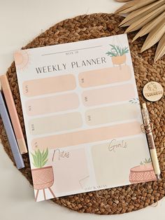 the weekly planner is sitting on top of a straw mat next to a pen and pencil