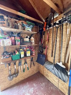 the inside of a garage with tools hanging on the wall