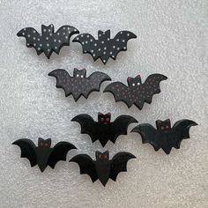 five bats with polka dots and black wings