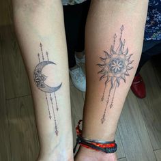 two people with matching tattoos on their legs, one has a sun and the other has a moon