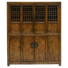 an old wooden cabinet with iron bars on the doors