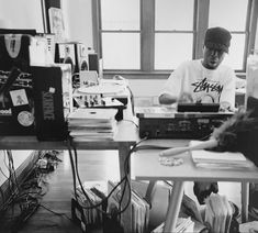 black and white photograph of two men working on electronics