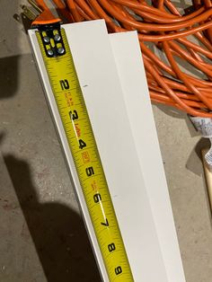 there is a measuring tape next to some orange wires