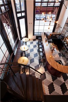 an overhead view of a restaurant with stairs leading up to the second floor and bar area