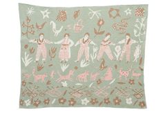 an embroidered pillow with people and animals on it