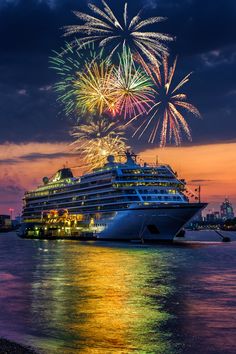 fireworks are lit up the sky above a cruise ship