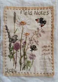 a piece of cloth with flowers and butterflies on it, which reads field notes 2012