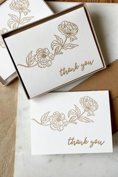 three thank you cards with gold foil flowers on them, sitting next to each other