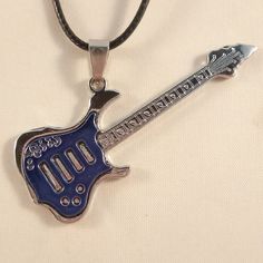 a blue guitar shaped pendant on a black cord