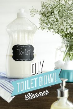 a bottle of toilet bowl cleaner next to a vase with baby's breath