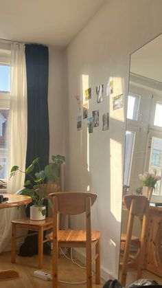 a living room filled with furniture and a large mirror on the wall next to a window