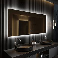 a bathroom with two sinks and a large mirror on the wall next to it's lights