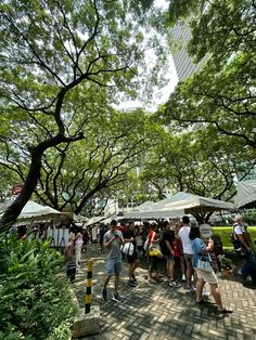 many people are walking around in the park